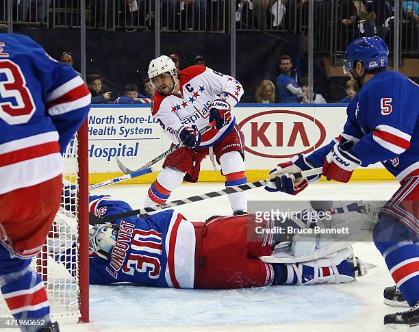 Henrik Lundqvist of the New York Rangers blocks a shot by Alex Ovechkin of the Washington Capitals during the first period in Game Two of the Eastern...