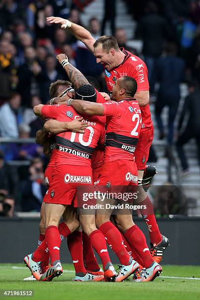 Drew Mitchell of Toulon is congratulated by teammates after scoring his team's second try during the European Rugby Champions Cup Final match between...