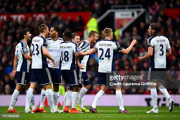 Chris Brunt of West Brom celebrates with team-mates after taking a free-kick which was deflected off Jonas Olsson of West Brom to score the opening...