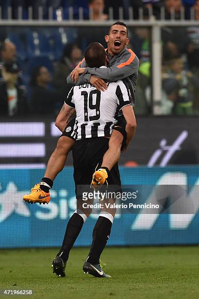 Leonardo Bonucci and Carlos Tevez of Juventus FC celebrate after beating UC Sampdoria 1-0 to win the Serie A Championships at the end of the Serie A...