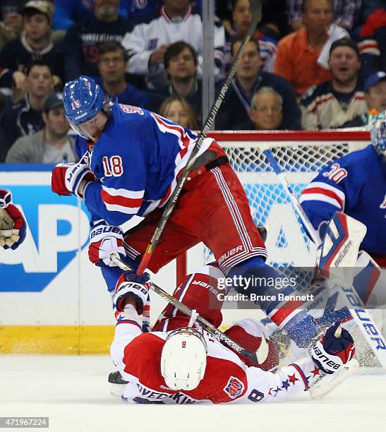 Marc Staal of the New York Rangers checks Alex Ovechkin of the Washington Capitals during the second period in Game Two of the Eastern Conference...