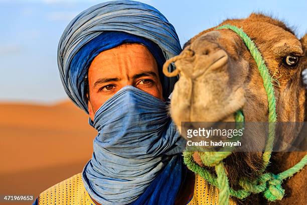young tuareg with camel on western sahara desert in africa - merzouga stockfoto's en -beelden