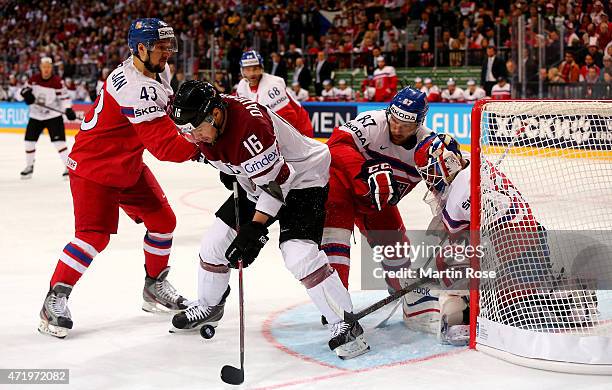 Kaspars Daugvanis of Latvia and Jakub Nakladal of Czech Republic battle for the puck during the IIHF World Championship group A match between Latvia...