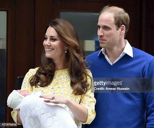 Catherine Duchess of Cambridge, wearing a Jenny Packham dress, and Prince William, Duke of Cambridge leave the Lindo Wing at St. Mary's Hospital with...