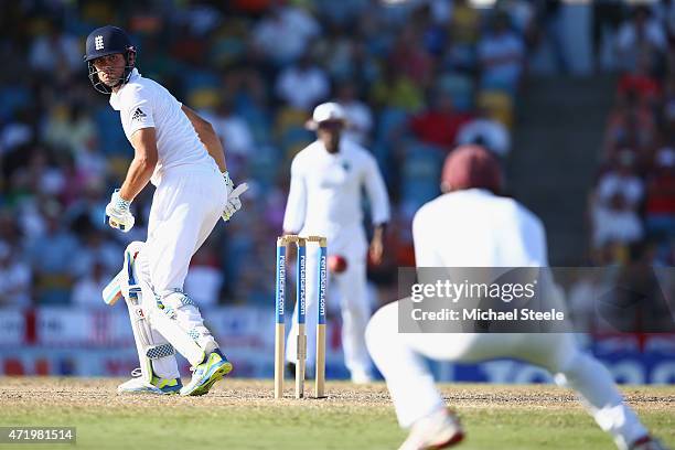 Alastair Cook of England looks back as he edges a catch to Kraigg Brathwaite of West Indies at slip to be dismissed off the bowling of Shannon...