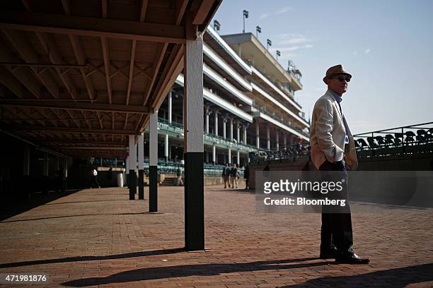 Race-goer surveys the grandstand at Churchill Downs before the crowds arrive on the morning of the 141st Kentucky Derby in Louisville, Kentucky,...