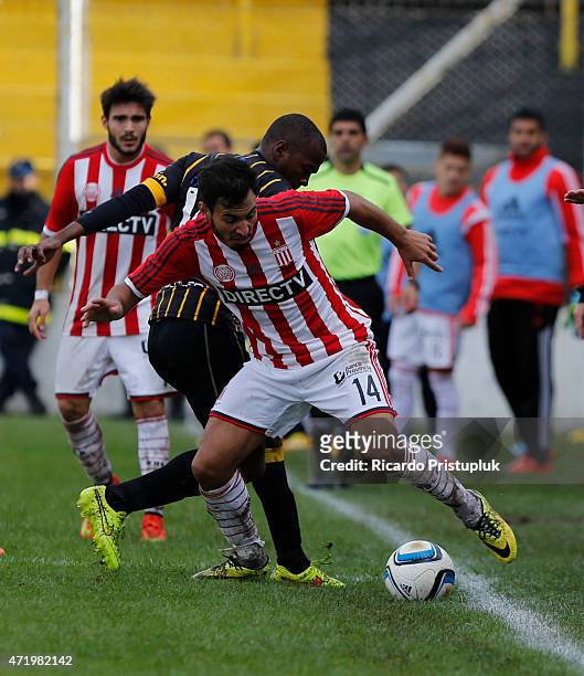 Juan Sanchez Miño of Estudiantes fights for the ball with Alex Bolaños of Olimpo during a match between Olimpo and Estudiantes as part of 11th round...