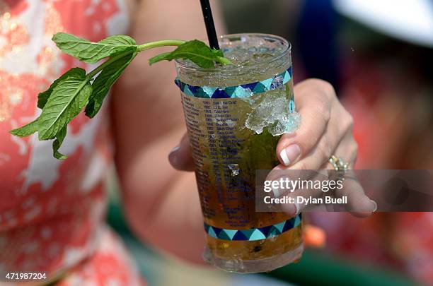 Detailed view of a woman posing with a Mint Julep looks on prior to the 141st running of the Kentucky Derby at Churchill Downs on May 2, 2015 in...