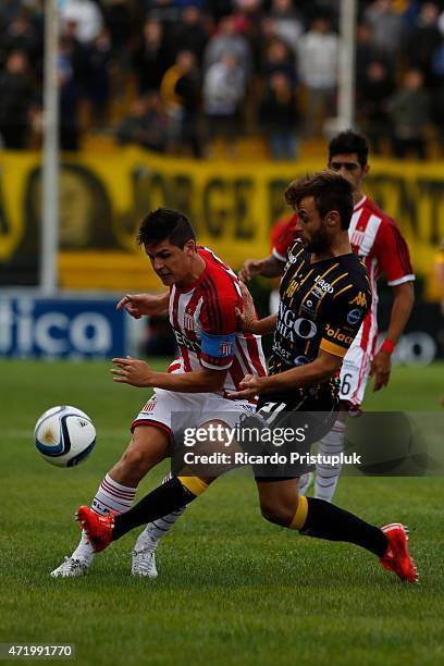 Guido Carrillo of Estudiantes fights for the ball with Juan Sills of Olimpo during a match between Olimpo and Estudiantes as part of 11th round of...