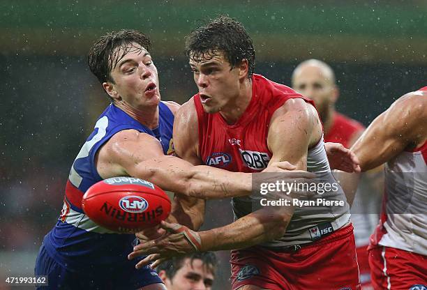 Liam Picken of the Bulldogs tackles Mike Pyke of the Swans during the round five AFL match between the Sydney Swans and the Western Bulldogs at SCG...