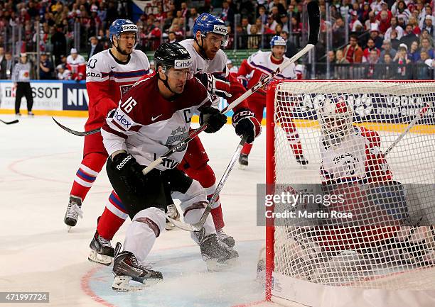 Kaspars Daugvanis of Latvia and Jakub Nakladal of Czech Republic battle for the puck during the IIHF World Championship group A match between Latvia...