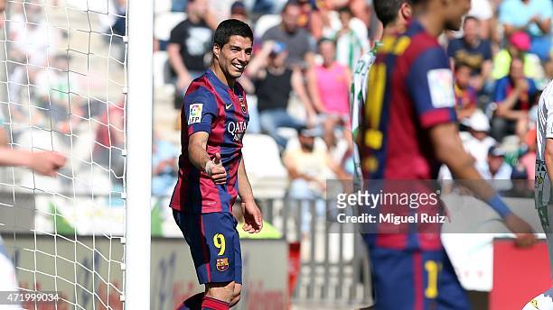 Luis Suarez of FC Barcelona congratulates his team-mate Lionel Messi for scoring the sixth goal during the La Liga match between Cordoba CF and FC...