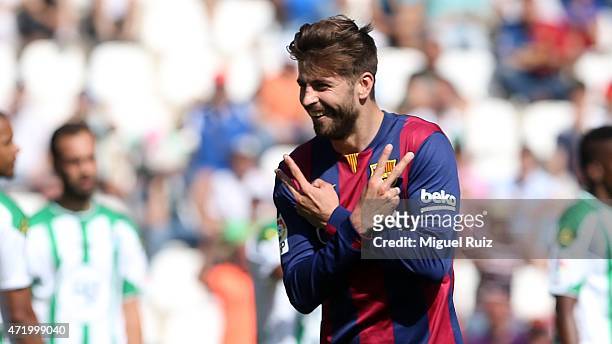 Gerard Pique of FC Barcelona celebrates scoring the fifth goal during the La Liga match between Cordoba CF and FC Barcelona at Nuevo Arcange on May...