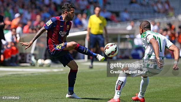 Dani Alves of FC Barcelona competes for the ball with Edimar of Cordoba CF during the La Liga match between Cordoba CF and FC Barcelona at Nuevo...