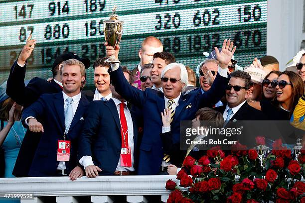 Trainer Bob Baffert of American Pharoah celebrates with the trophy in winners circle after winning the 141st running of the Kentucky Derby at...