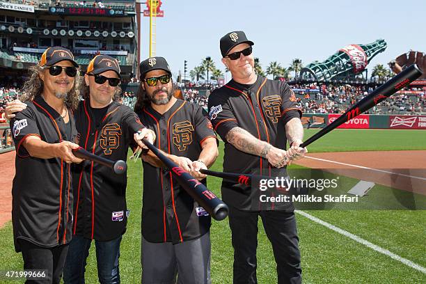 Guitarist Kirk Hammett, drummer Lars Ulrich, bassist Robert Trujillo and vocalist James Hetfield of Metallica pose for photos before the game at...