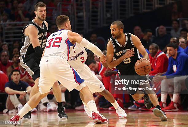 Tony Parker of the San Antonio Spurs drives around Blake Griffin and Chris Paul of the Los Angeles Clippers during Game Seven of the Western...