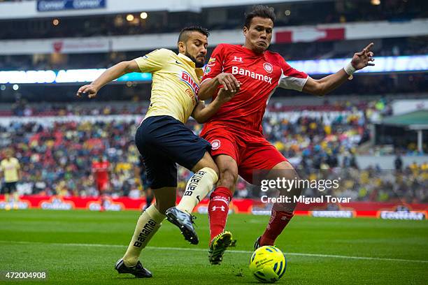 Jose Guerrero of America fights for the ball with Aaron Galindo of Toluca during a match between America and Toluca as part of 16th round of Clausura...