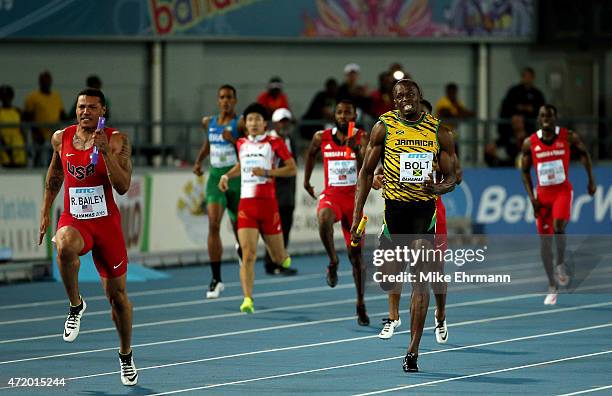 Ryan Bailey of the United States and Usain Bolt of Jamaica compete during the final of the mens 4 x 100 metres on day one of the IAAF World Relays...