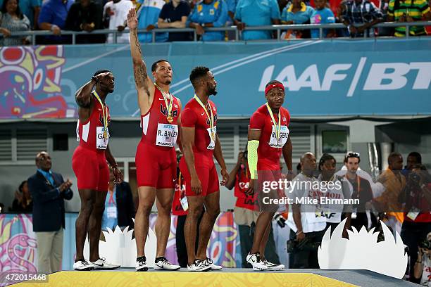 Justin Gatlin, Ryan Bailey, Tyson Gay, and Mike Rodgers of the United States stand on the podium after winning the final of the mens 4 x 100 metres...