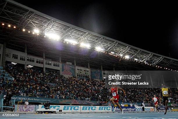 Ryan Bailey of the United States and Usain Bolt of Jamaica compete during the final of the mens 4 x 100 metres on day one of the IAAF World Relays...