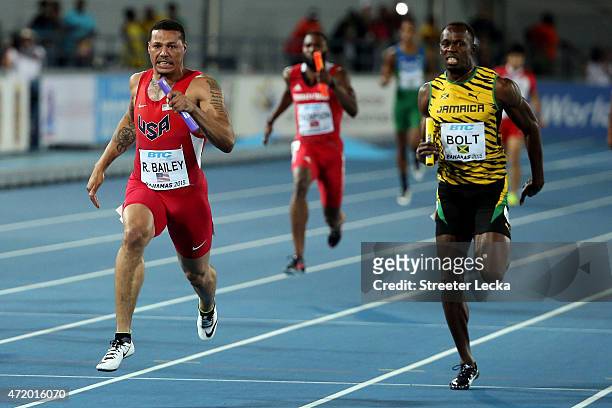 Ryan Bailey of the United States and Usain Bolt of Jamaica compete during the final of the mens 4 x 100 metres on day one of the IAAF World Relays...