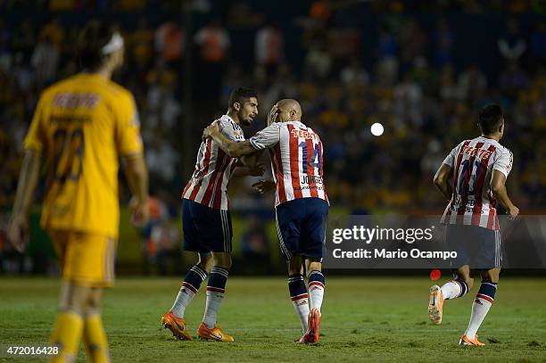 Jorge Enriquez of Chivas celebrates with teammates after scoring his team's first goal during a match between Tigres UANL and Chivas as part of 16th...