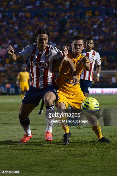 Israel Jimenez of Tigres fights for the ball with Aldo De Nigris of Chivas during a match between Tigres UANL and Chivas as part of 16th round of...