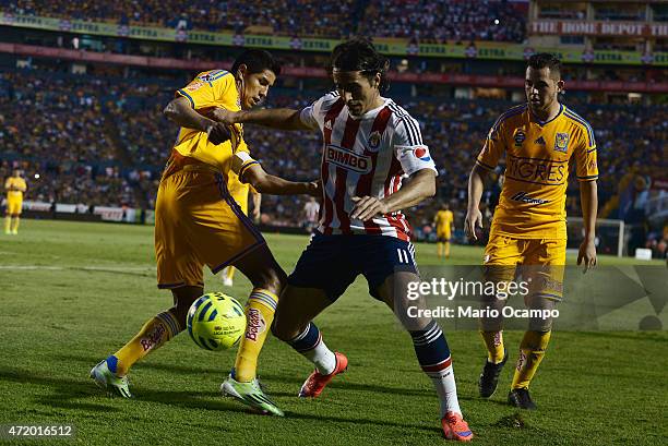 Hugo Ayala of Tigres fights for the ball with Aldo De Nigris of Chivas during a match between Tigres UANL and Chivas as part of 16th round of...