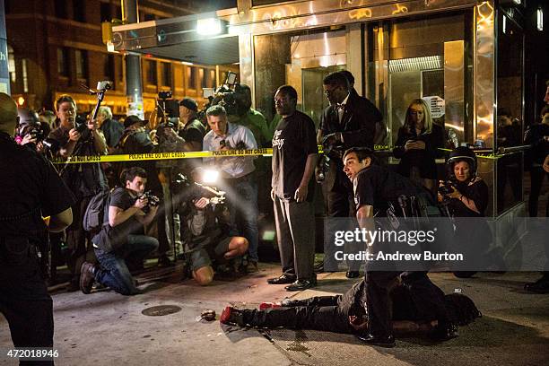 Man is detained after being pepper sprayed in the face by police at the end of a day of protests in the Sandtown neighborhood where Freddie Gray was...