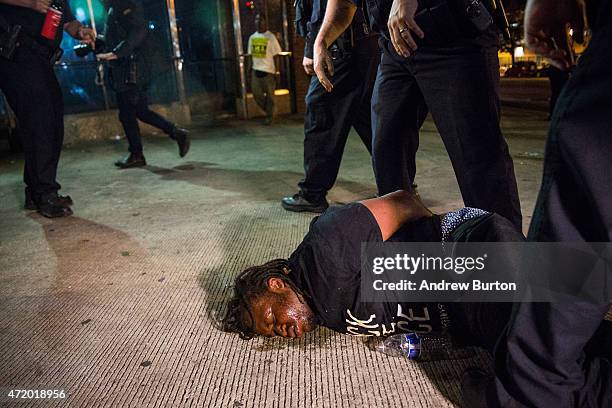 Man is detained after being pepper sprayed in the face by police at the end of a day of protests in the Sandtown neighborhood where Freddie Gray was...