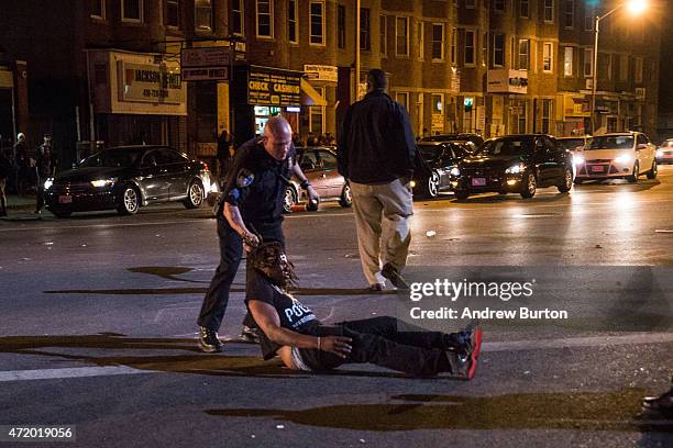 Man is detained after being pepper sprayed in the face by police at the end of a day of protests in the Sandtown neighborhood where Freddie Gray was...