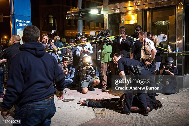 Man is detained after being pepper sprayed in the face by police at the end of a day of protests in the Sandtown neighborhood where Freddie Gray was...