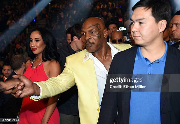 Former boxer Mike Tyson shakes hands ringside as he and his wife Lakiha "Kiki" Tyson arrive at "Mayweather VS Pacquiao" presented by SHOWTIME PPV And...