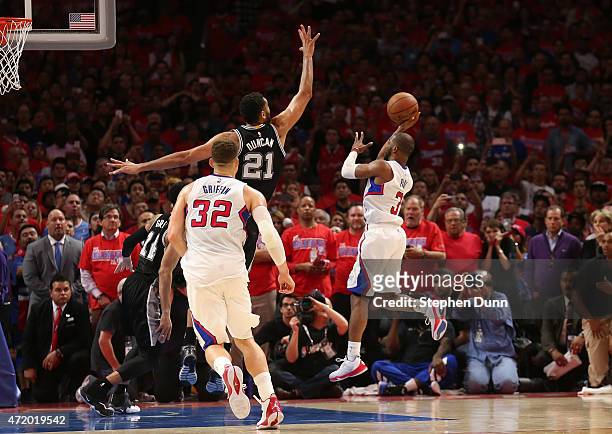 Chris Paul of the Los Angeles Clippers puts up the game winning shot over Tim Duncan of the San Antonio Spurs with one second remaining in Game Seven...