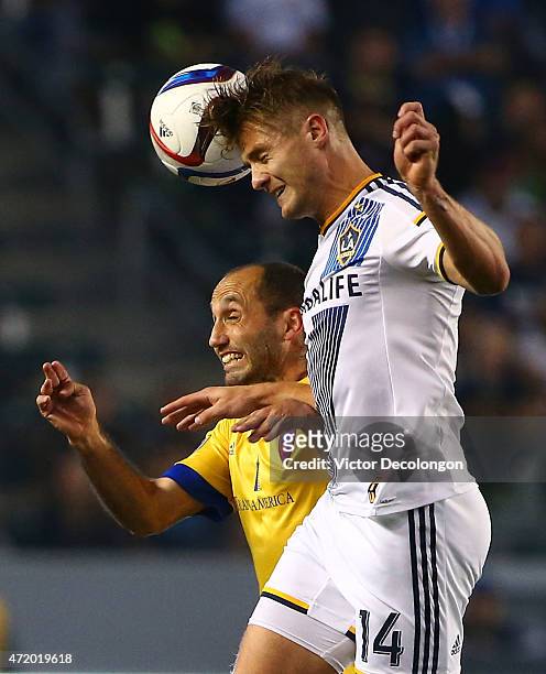 Robbie Rogers of Los Angeles Galaxy wins a header against Nick LaBrocca of the Colorado Rapids in the first half during the MLS match at StubHub...