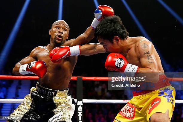 Floyd Mayweather Jr. And Manny Pacquiao exchange punches during their welterweight unification championship bout on May 2, 2015 at MGM Grand Garden...