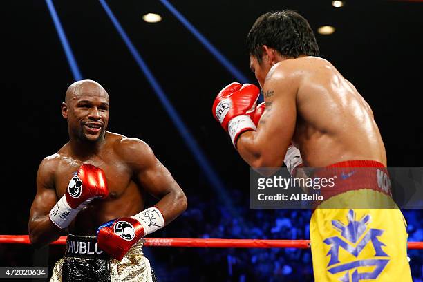 Floyd Mayweather Jr. Smiles at Manny Pacquiao during their welterweight unification championship bout on May 2, 2015 at MGM Grand Garden Arena in Las...