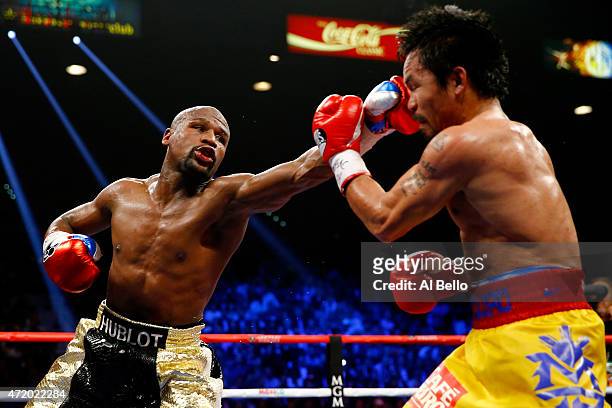Floyd Mayweather Jr. Throws a left at Manny Pacquiao during their welterweight unification championship bout on May 2, 2015 at MGM Grand Garden Arena...