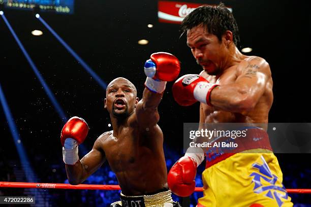 Floyd Mayweather Jr. Throws a left at Manny Pacquiao during their welterweight unification championship bout on May 2, 2015 at MGM Grand Garden Arena...