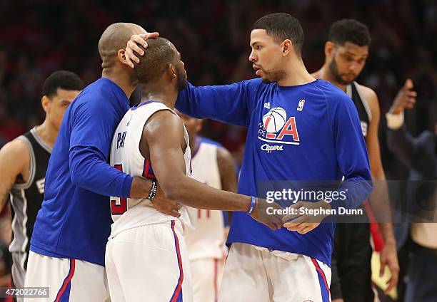 Chris Paul the Los Angeles Clippers is congratulated by Austin Rivers and Dahntay Jones after Paul made a basket with one second remaining to give...