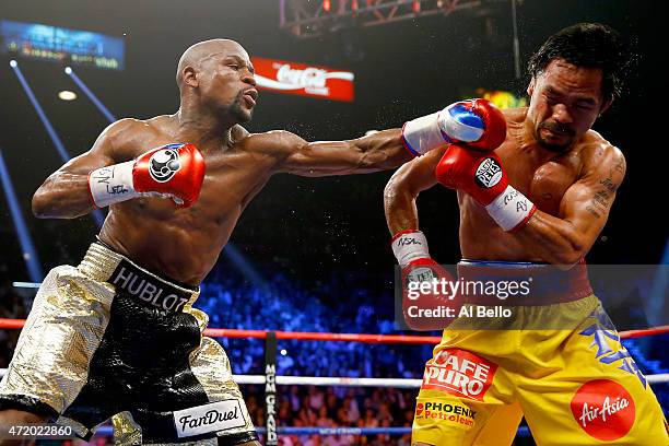 Floyd Mayweather Jr. Throws a left at Manny Pacquiao during their welterweight unification championship bout on May 2, 2015 at MGM Grand Garden Arena...