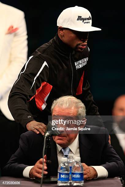 Floyd Mayweather Jr. Puts his hand on the shoulder of Bob Arum of Top Rank during the post-fight news conference after his unanimous decision victory...