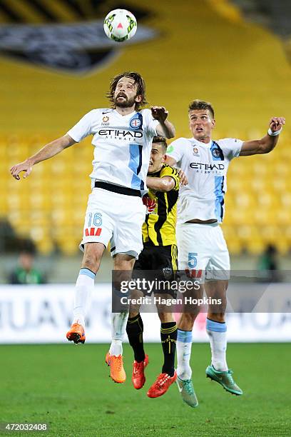 Joshua Kennedy and Erik Paartalu of Melbourne City contest a header with Louis Fenton of the Phoenix during the A-League Elimination match between...