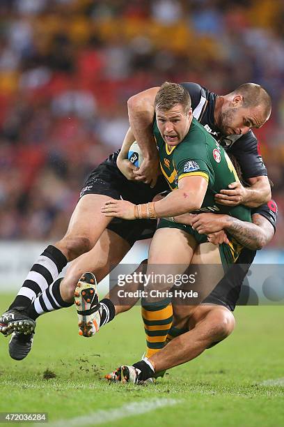 Trent Merrin of Austrlalia is tackled by Simon Mannering of New Zealand during the Trans-Tasman Test match between the Australia Kangaroos and the...
