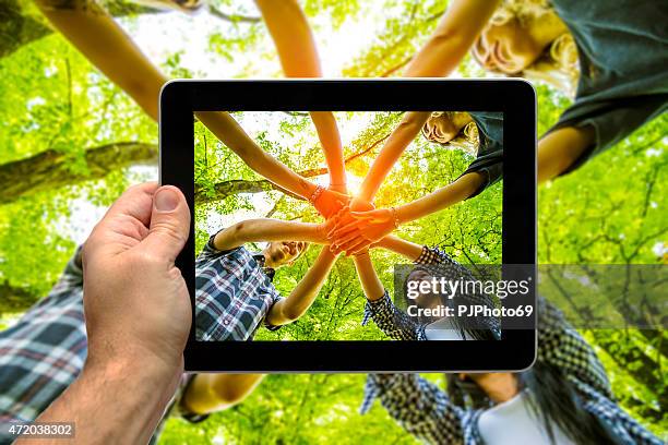 photographing group of friends with hands in hands - teamwork - hands together stock pictures, royalty-free photos & images