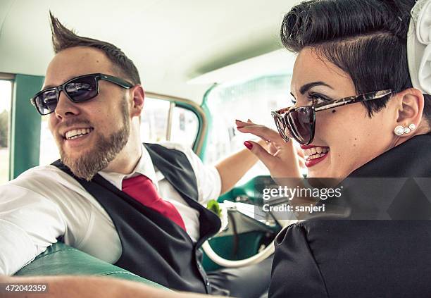 couple in a retro car on the road - rockabilly stock pictures, royalty-free photos & images
