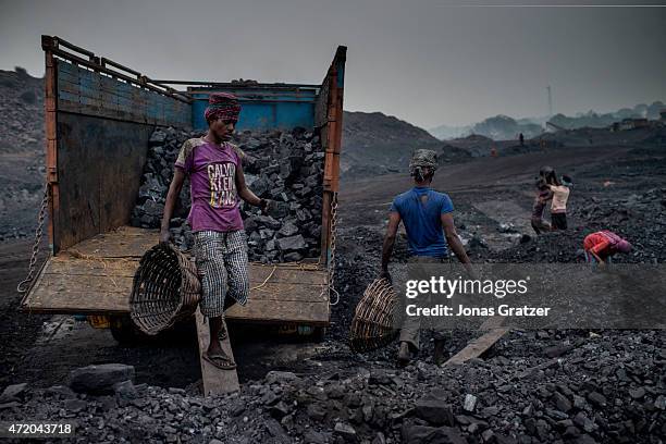 Workers in Jharia are loading a truck with coal using baskets that they carry on top of their heads. Jharia in India's eastern Jharkand state is...