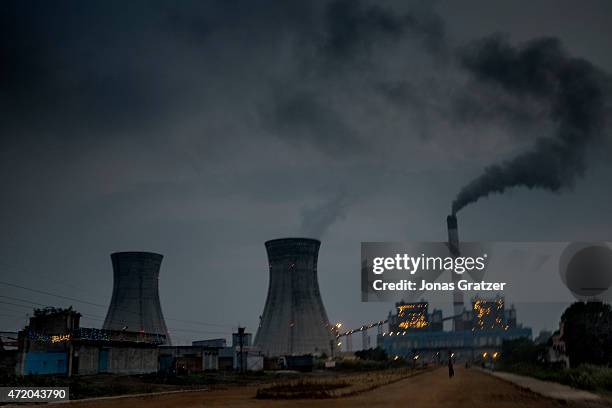 Dirty black smoke spewing out of a chimney at a coal power plant in the Indian state of Jharkhand. Jharia in India's eastern Jharkand state is...