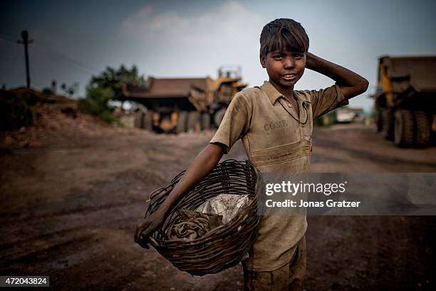 Child laborer working at a coal mine in Jharia. Jharia in India's eastern Jharkand state is literally in flames. This is due to the open cast coal...